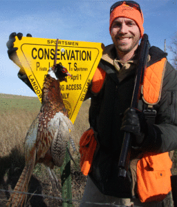hunter with ring-neck pheasant