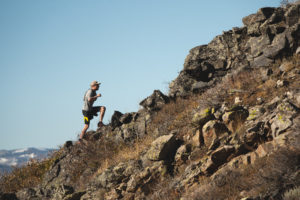 Patrick running up a rocky hill