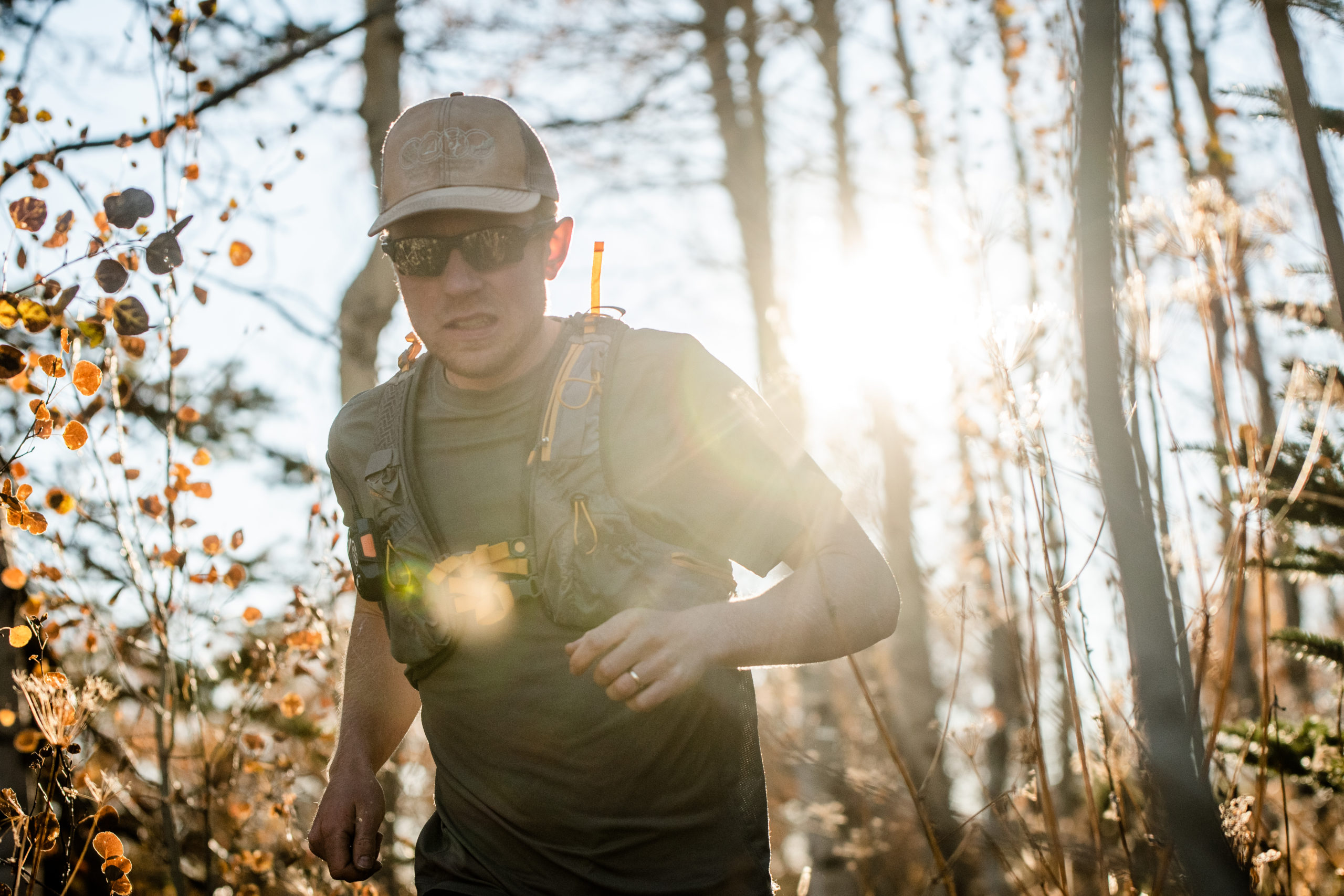 Patrick facing the camera, running with the sun hitting his back