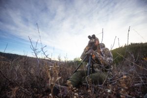 hunter looking through binoculars