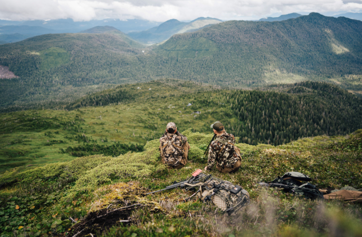 Hunters look out at a mountainous vista in the Tongass National Forest.