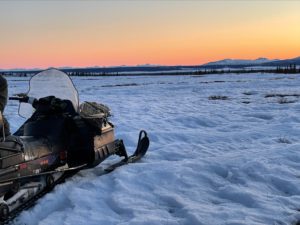 snow mobile at sunrise in the mountains